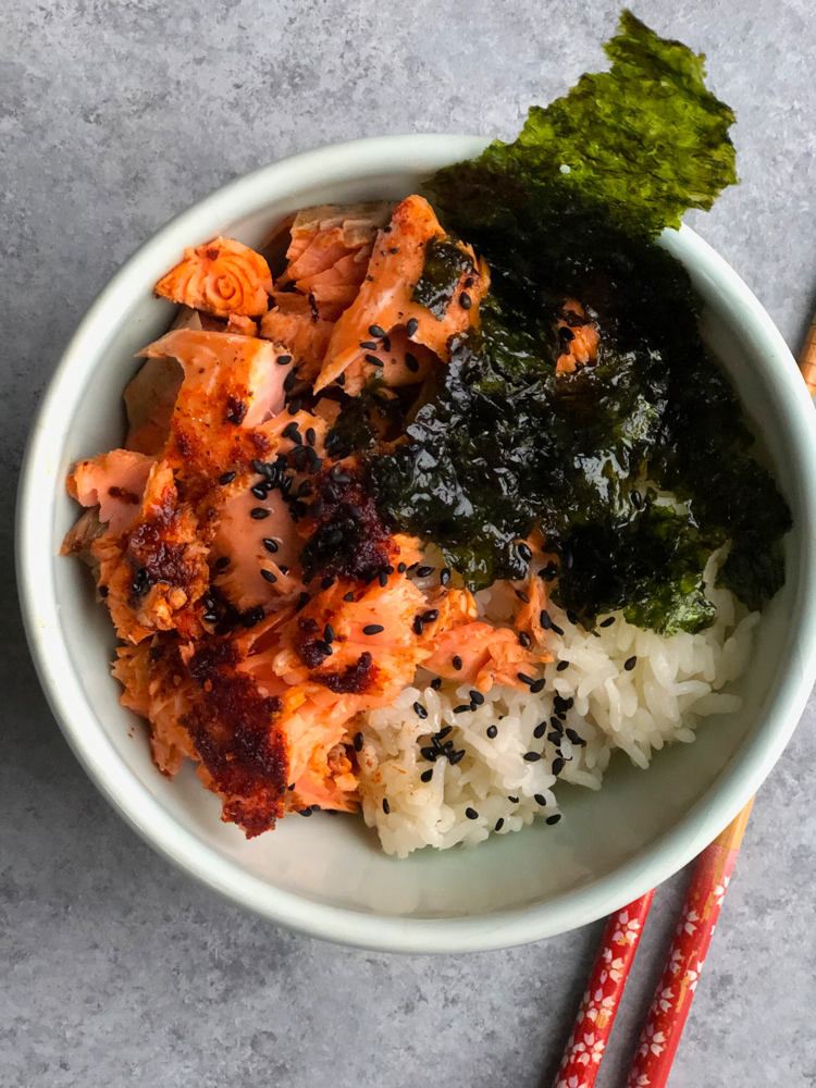 Asian Salmon Rice Bowl! Seasoned lemon pepper baked salmon served over rice with a hint of sesame oil and served with nori.