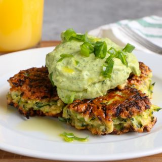 Zucchini Fritters with Avocado Crema!! It's all about brunch with a healthy twist! Savory and delicious and topped with a fresh avocado crema!