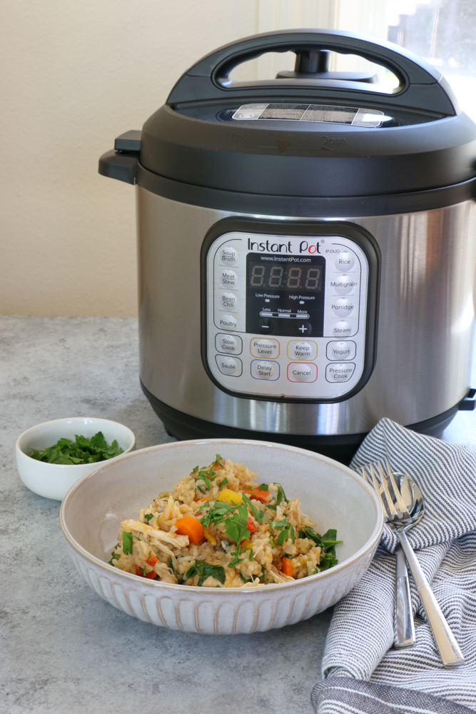 Instant Pot Chicken and Rice. So easy and delicious and made in a fraction of the time with my Instant Pot! You'll want to put this recipe into your family's meal rotation today!