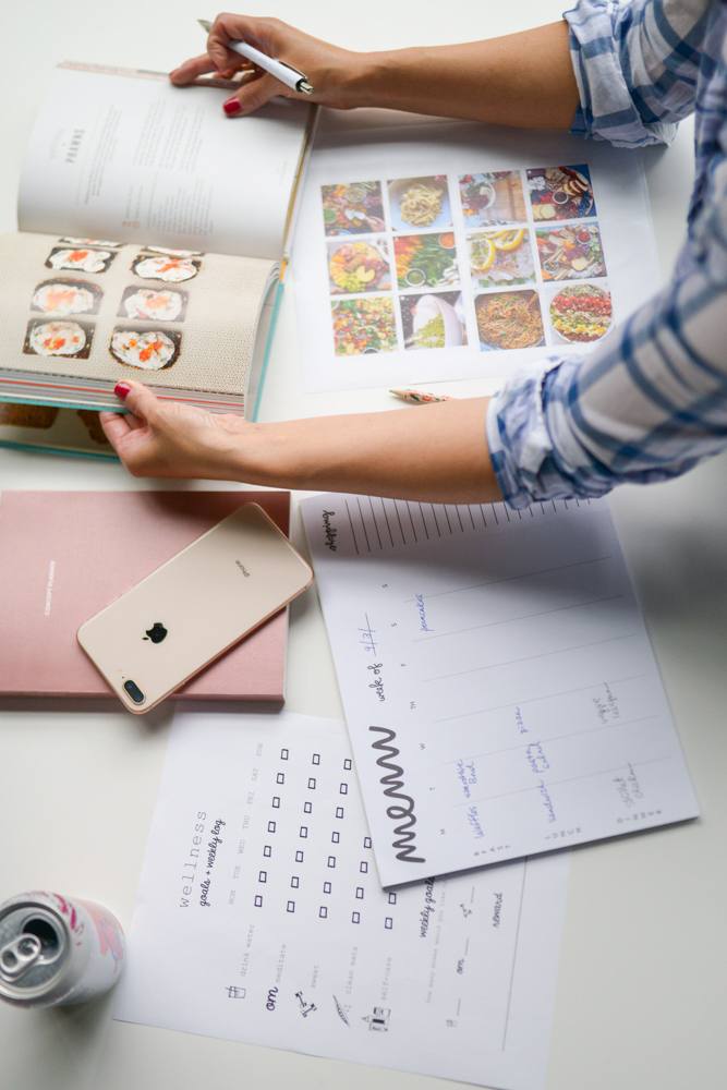 woman looking at cookbook for easy meal plan ideas