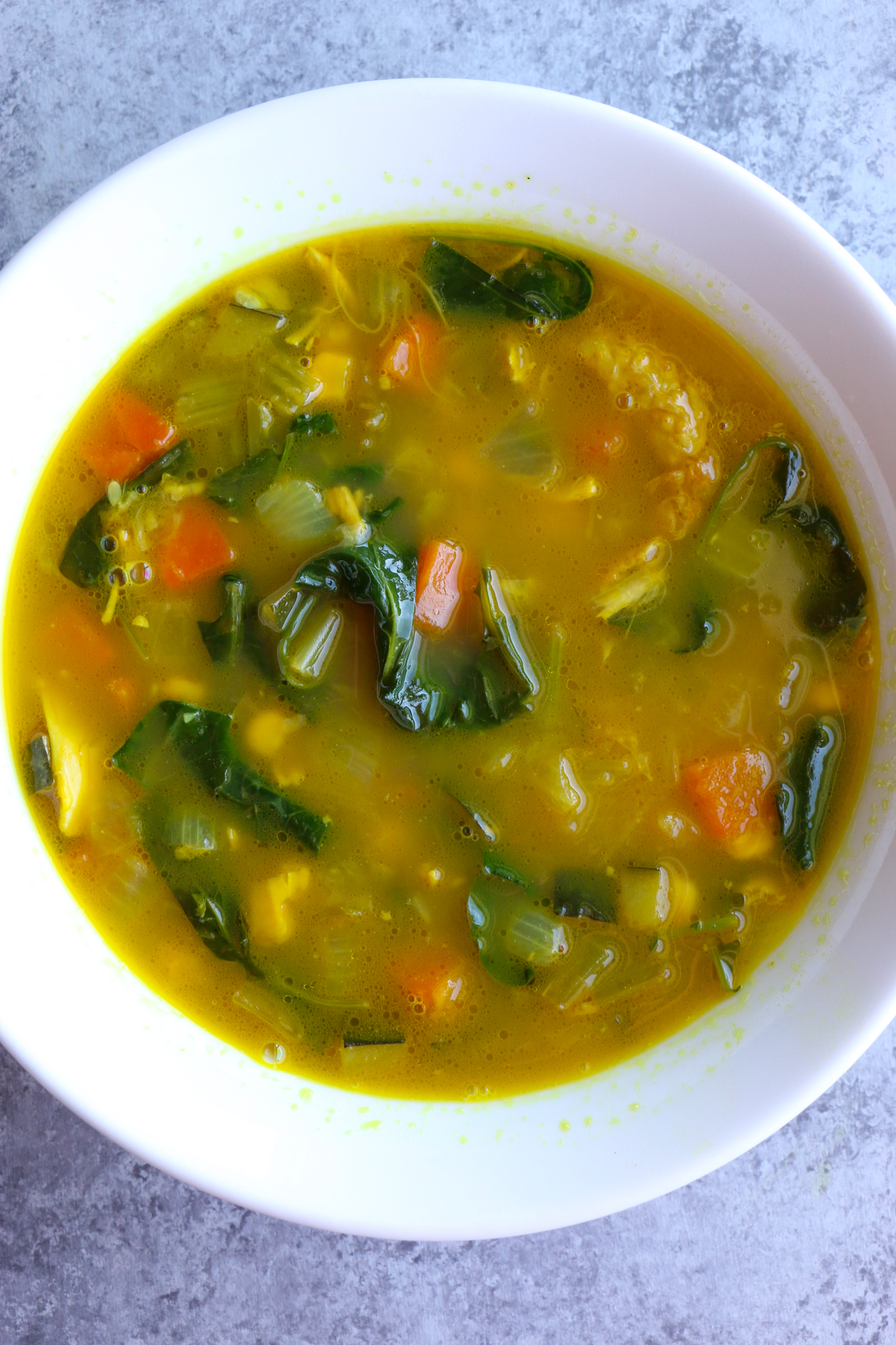 Immunity Boosting Turmeric Chicken Soup with carrots, onions, celery, zucchini, corn, kale and spinach. Not only is this soup packed with vegetables, but also immune system boosters like turmeric, ginger, garlic and spinach! You've got to try this!