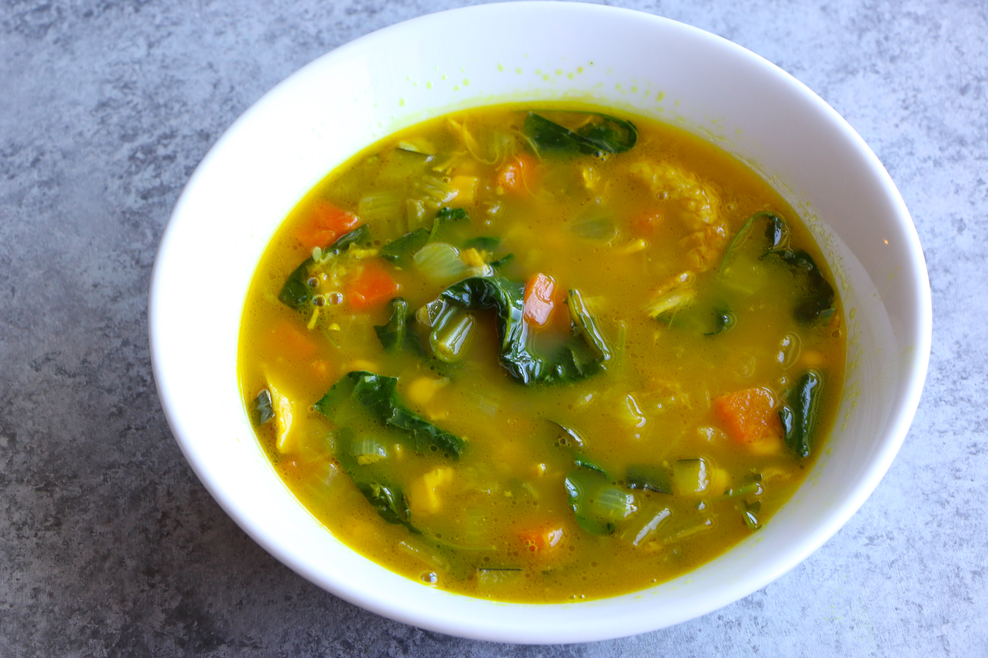 Immunity Boosting Turmeric Chicken Soup with carrots, onions, celery, zucchini, corn, kale and spinach. Not only is this soup packed with vegetables, but also immune system boosters like turmeric, ginger, garlic and spinach! You've got to try this!