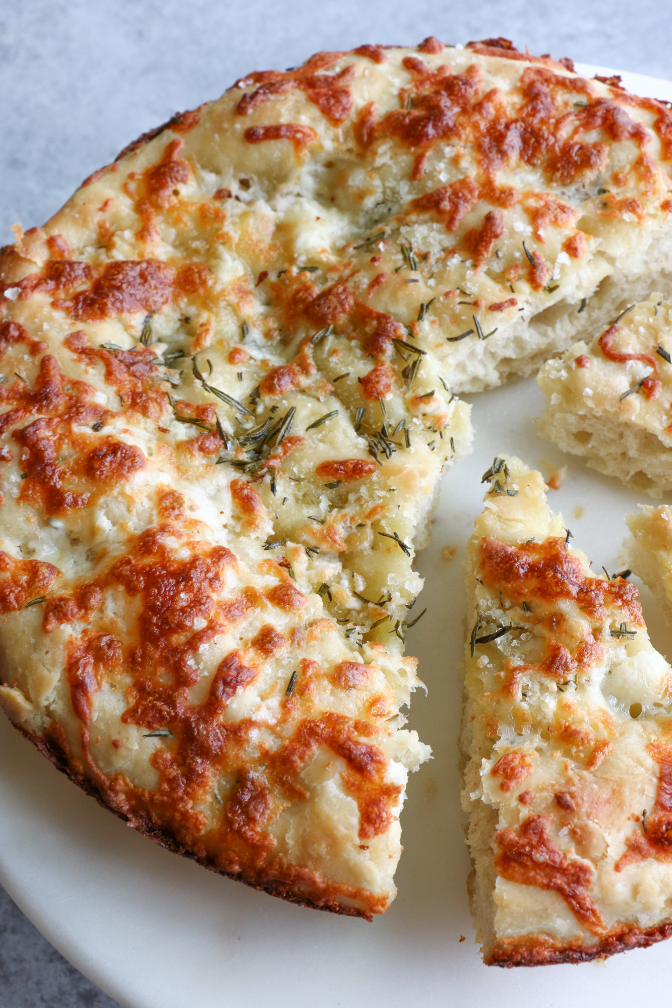 Rosemary Focaccia Bread using the pan pizza dough recipe from Food 52. This recipe takes time but is so worth it and super versatile. Try this if you like crispy edges and a pillowy, fluffy center for your dough. It's so good!