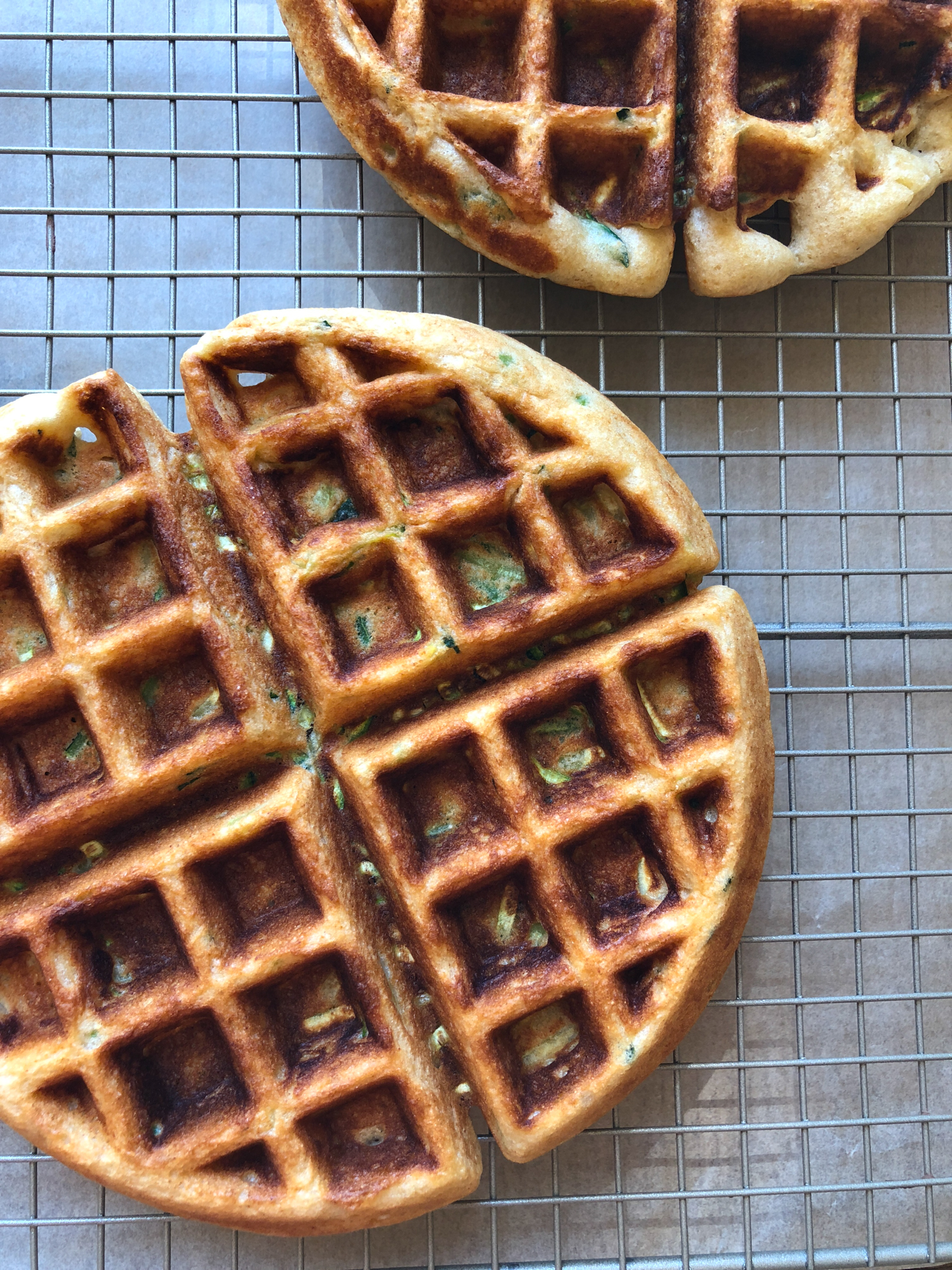 How To Make Zucchini Waffles! A delicious way to incorporate more veggies into your meal! They are so easy to make and THE BEST tasting homemade waffles ever! Don&rsquo;t forget the fresh fruit, butter and maple syrup!