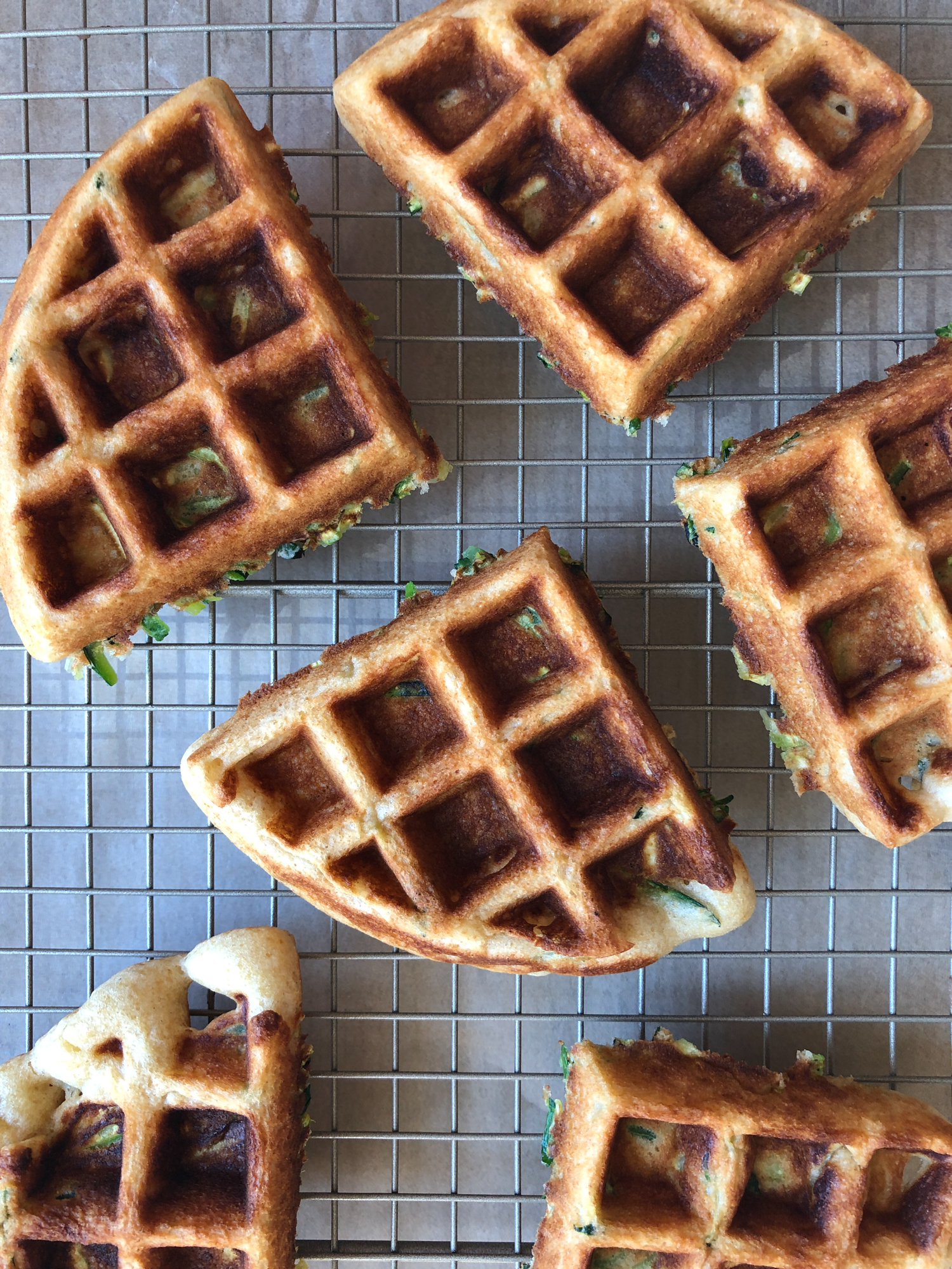 How To Make Zucchini Waffles! A delicious way to incorporate more veggies into your meal! They are so easy to make and THE BEST tasting homemade waffles ever! Don&rsquo;t forget the fresh fruit, butter and maple syrup!