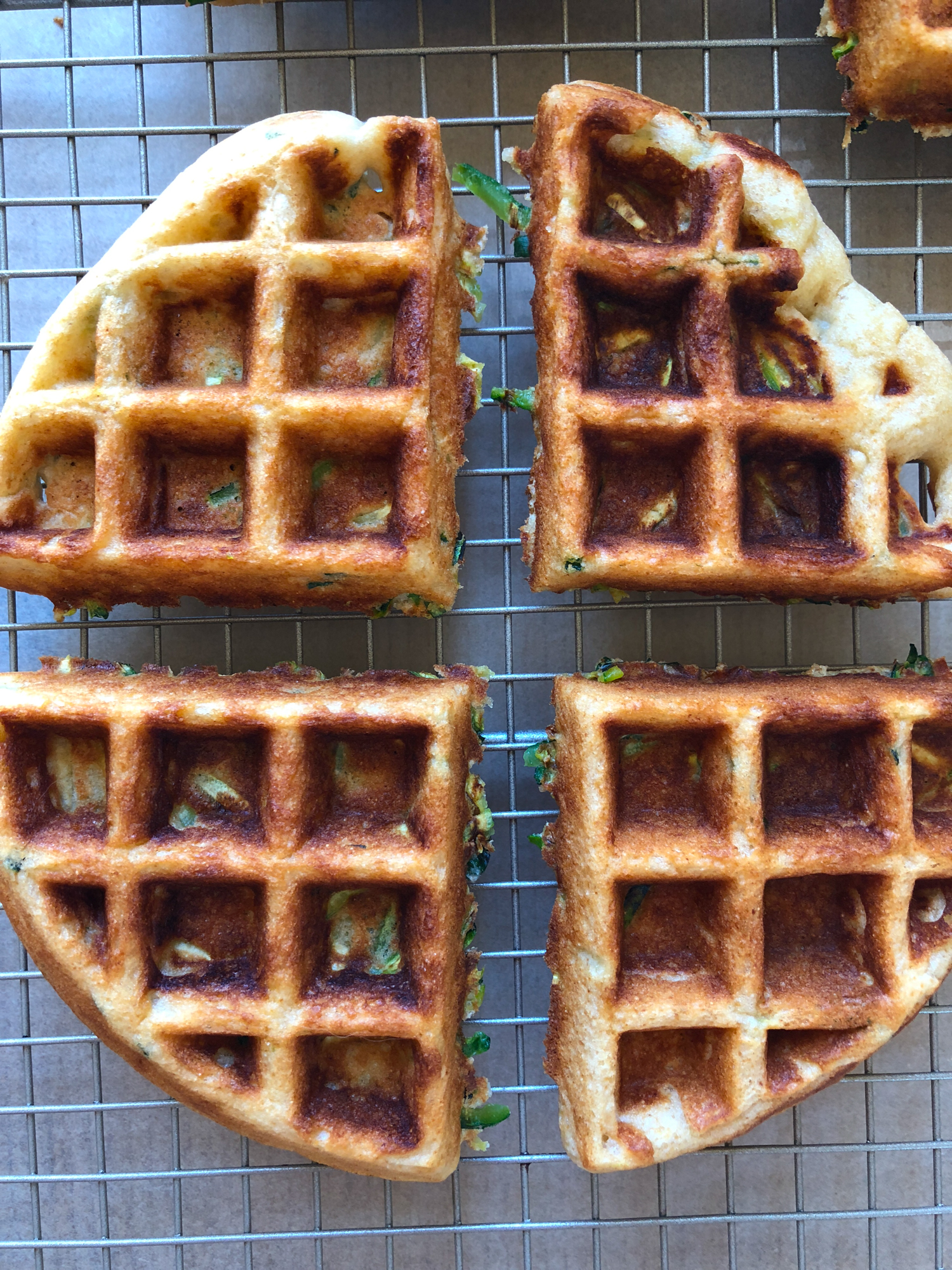 How To Make Zucchini Waffles! A delicious way to incorporate more veggies into your meal! They are so easy to make and THE BEST tasting homemade waffles ever! Don&rsquo;t forget the fresh fruit, butter and maple syrup!
