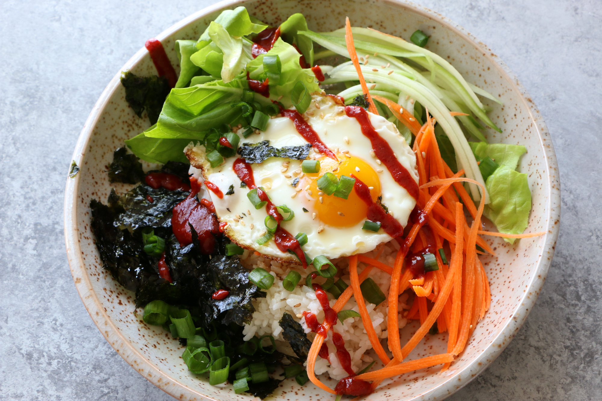 How To Make Breakfast Bibimbap! Filled with just some raw veggies and topped with a fried egg, this is one breakfast you will love!