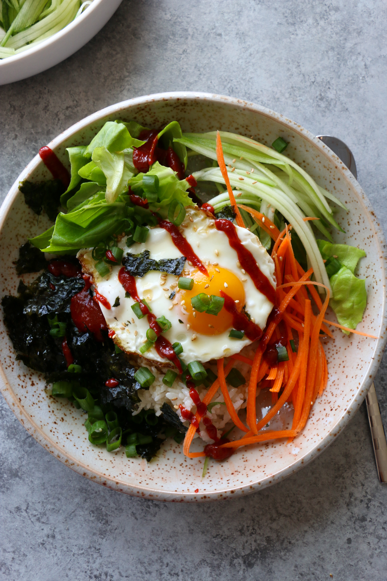 How To Make Breakfast Bibimbap! Filled with just some raw veggies and topped with a fried egg, this is one breakfast you will love!