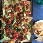 Loaded Sheet Pan Nachos! Packed with ground beef, and lot of cheese and vegetables, this one is a family favorite for sure! So easy to make!