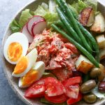 Salmon Nicoise Salad with roasted salmon, potatoes, haricots verts, tomatoes, eggs and olives, topped with a delicious vinaigrette!