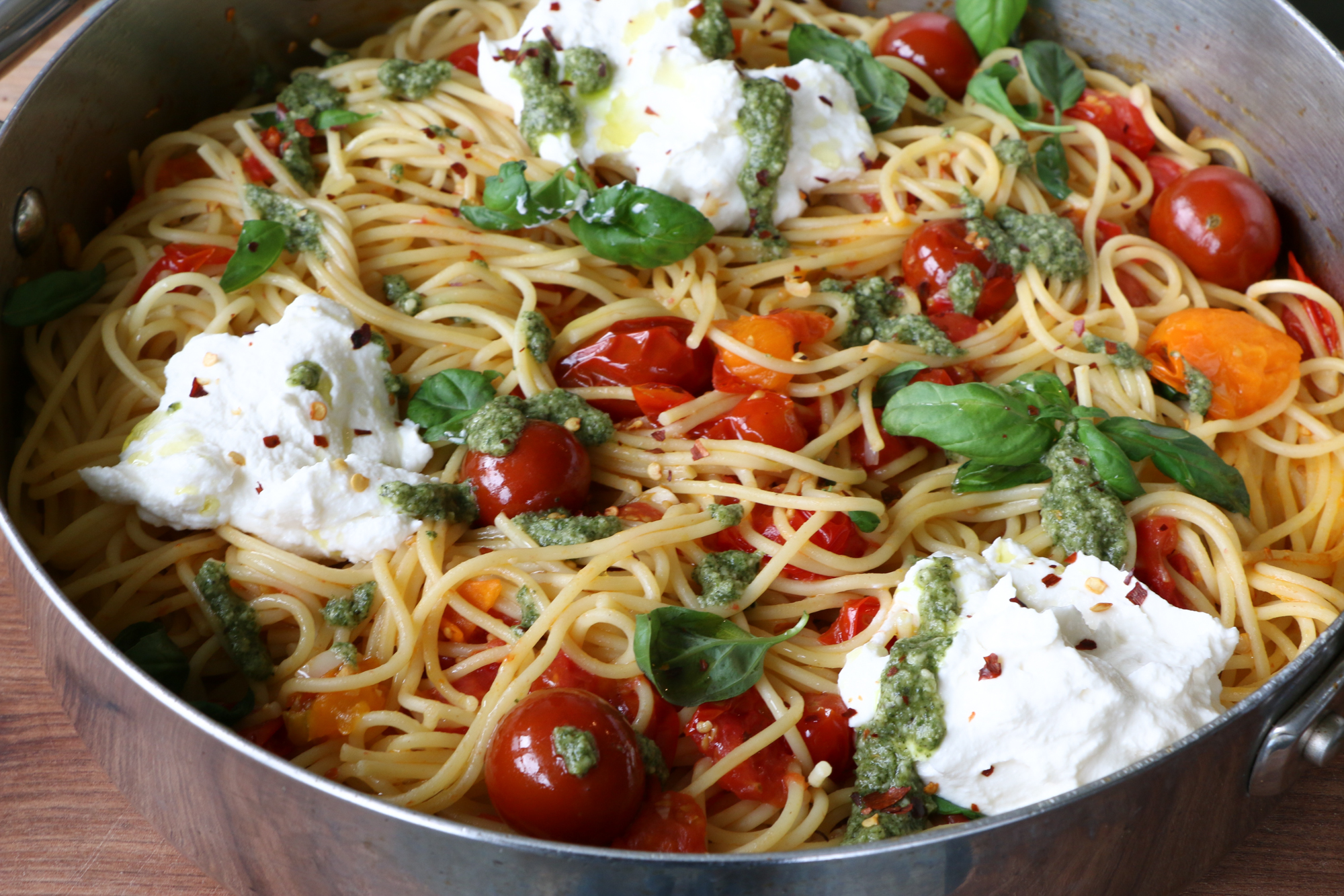 Spaghetti with Ricotta and Tomatoes! Creamy, flavorful and so delicious! This one comes together in under 30 minutes and is absolutely delicious. The ricotta makes the pasta creamier and the pesto takes the entire dish up a notch in my opinion. Mix everything together and it's heaven. Hope you try it!