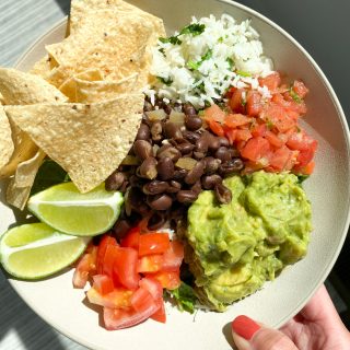 Chipotle Style Salad Bowl! Cilantro lime rice, shredded romaine lettuce, black beans, guacamole, pico de gallo, tortilla chips and more.