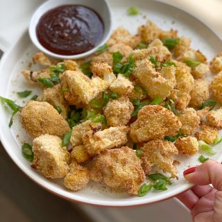 Crispy Cauliflower with Gochujang Ketchup! Chunks of seasoned, breaded cauliflower baked to perfection and served with gochujang ketchup!