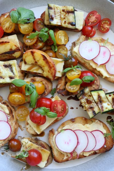Summer Crostini with Truly Grass Fed butter and cheese! Toasted or grilled bread with aged cheddar, tomatoes, grilled zucchini and more!