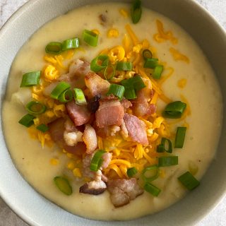 Loaded Baked Potato Soup! Filled with potato chunks, creamy goodness and topped with cheddar cheese and bacon bits.