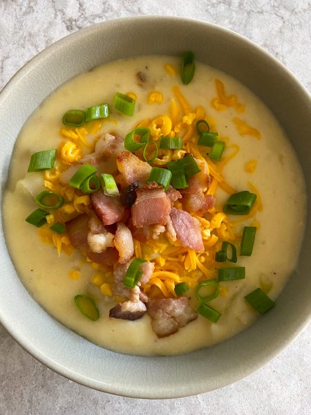 Loaded Baked Potato Soup! Filled with potato chunks, creamy goodness and topped with cheddar cheese and bacon bits.