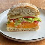 Roasted Butternut Squash Sandwich! Layers of roasted butternut squash, provolone, hot peppers, lettuce, tomato, onion, mayo, oil and vinegar.